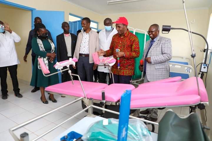 Nyandarua County Governor Francis Kimemia (in red cap) being shown some of the equipment.