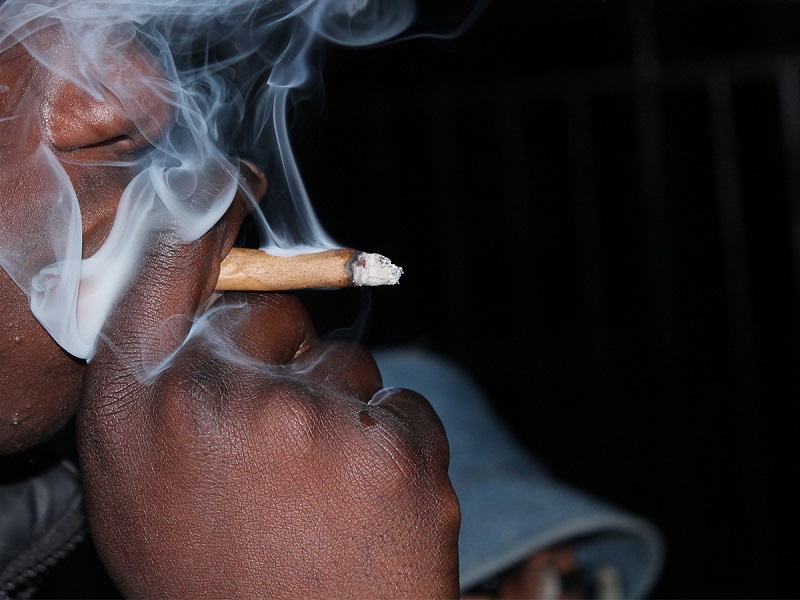 Photo of a young man smoking a cigarette