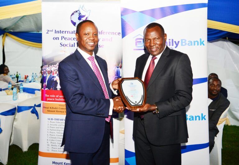 Family Bank Chief Commercial Officer, Ken Kaniu(l) receives a gift