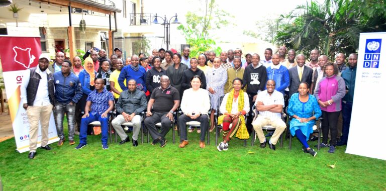 Journalists take photos with trainers after a training on Election held at Alba Hotel in Meru County