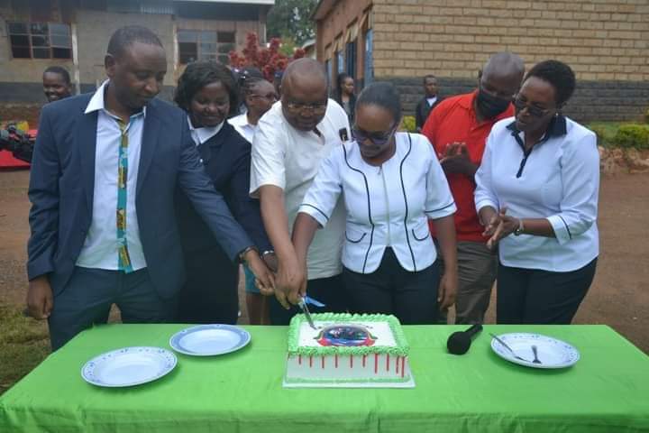 Nursing officials cutting a cake to commemorate the event