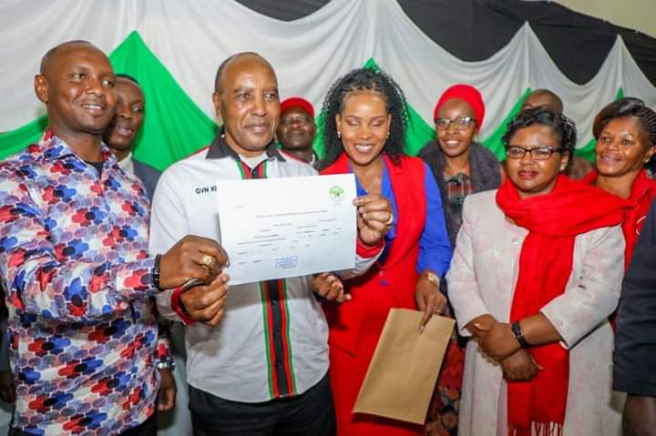Nyandarua Governor Francis Kimemia displaying his nomination certificate