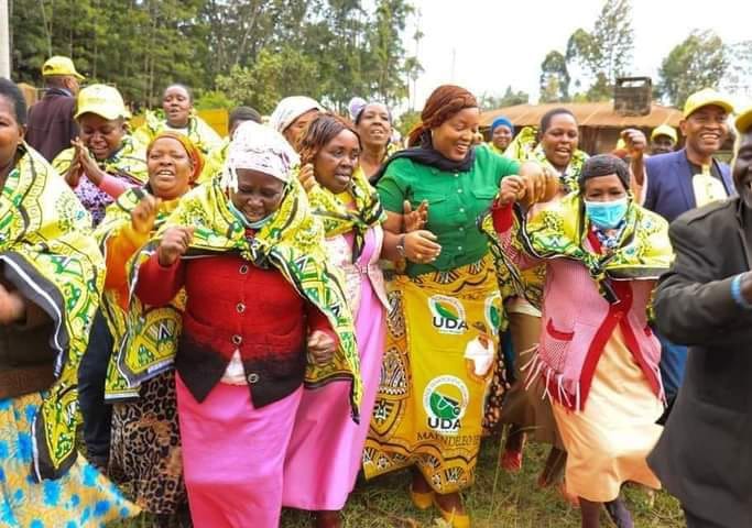 Nyeri County Women Representative Rahab Mukami Wachira (in green top) and Eng Wahome Wamatinga (right) joins Women dancers in Mahiga Ward, Othaya yesterday