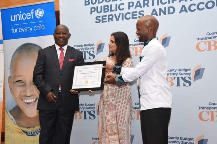 Nyeri County governor Mutahi Kahiga (left) receiving the certificate