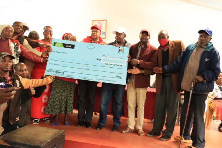 Othaya MP Gichuki Mugambi (in red cap) flanked by the area NG-CDF chairman Dr Muthoga Ngera