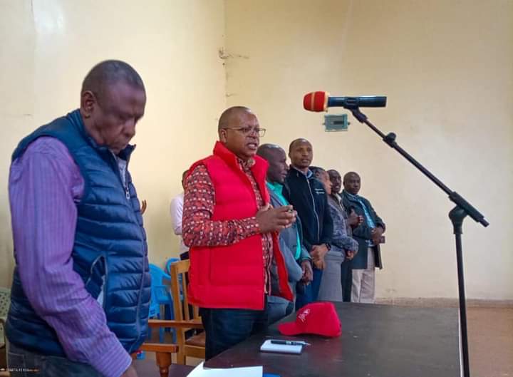 Othaya MP Gichuki Mugambi (in red jacket) with the area NG-CDF chairman Dr Muthoga Ngera (left) and other officials during the launching of bursary disbursement yesterday.