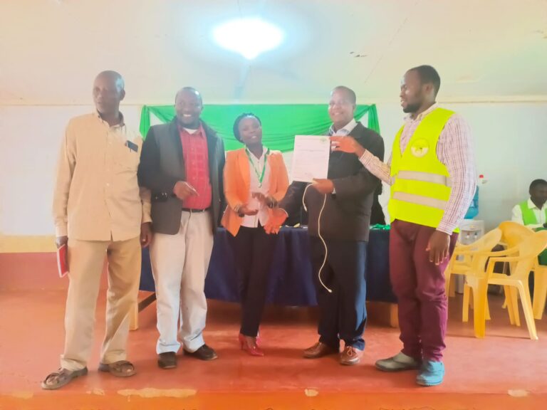 Tetu constituency parliamentary candidate on Muungano Party, Peter Wambugu Kamweru receiving his nomination certificate.