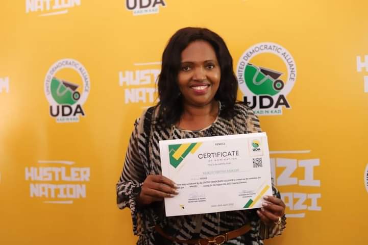 UDA Nakuru Senate aspirant Tabitha Karanja displaying her nomination certificate yesterday