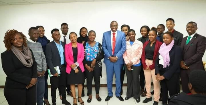 George Wachiuri (in blue suit) with some of mentees attached to his firm, Optiven