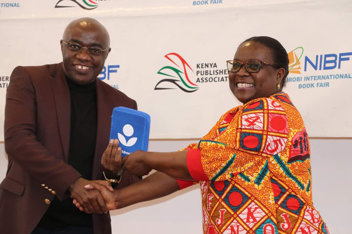 Worldreader Regional Manager East Africa Joan Mwachi presents a donation