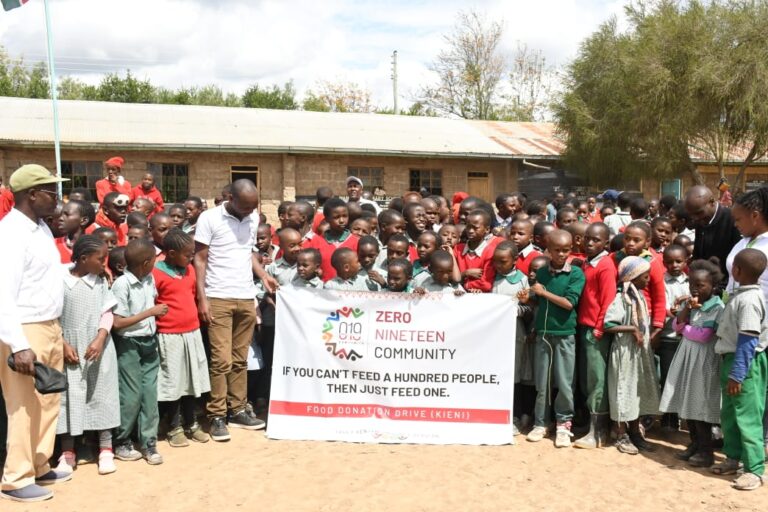 Members of Zero Nineteen Community with some pupils who were beneficiaries of the relief food donations