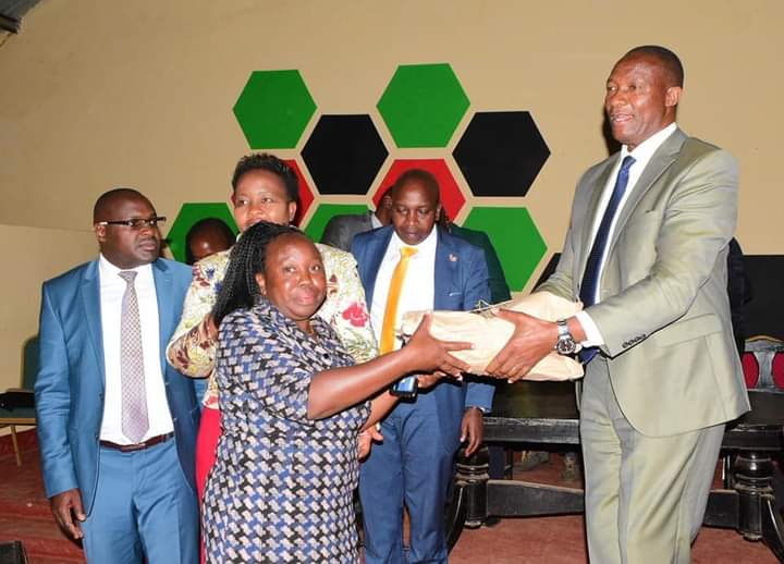 Nyandarua County Governor Moses Kiarie Badilisha presenting cheques yesterday