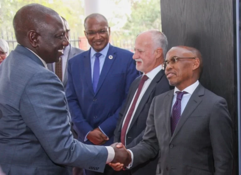 President William Ruto shakes hands with Safaricom CEO Peter Ndegwa