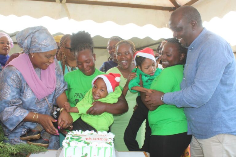 Ahadi Kenya Trust Chief Executive Officer Dr Stanley Kamau (right) with Chief Cabinet Secretary's spouse Tessy Mudavadi (left) with kids with special needs in Nyeri yesterday.