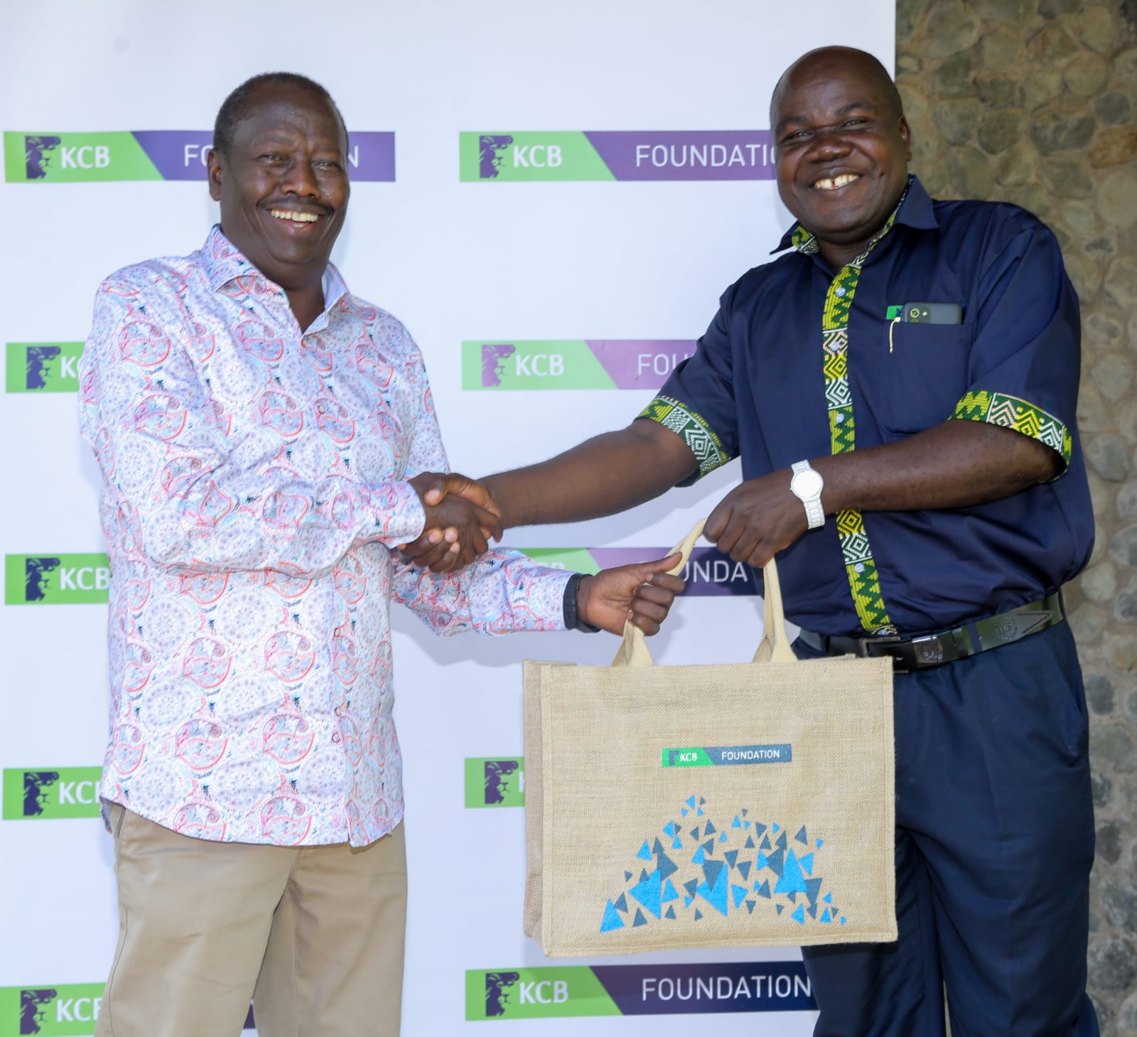 Baringo county Governor, H.E Benjamin Cheboi, (left) receives a token of appreciation from KCB Foundation Chairman, Austen Omonyo