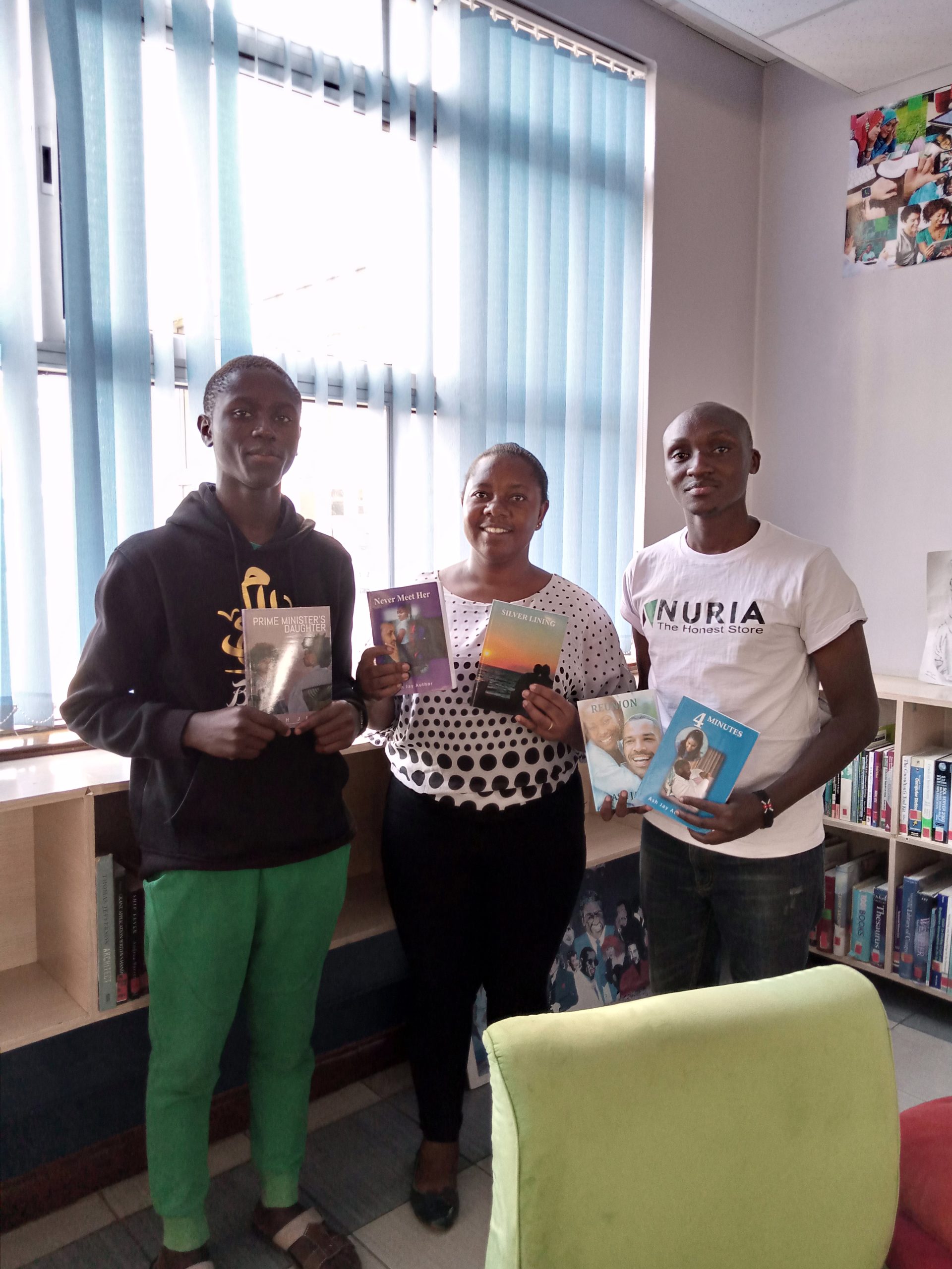Ash Jay (centre) showcasing some of her published novels.