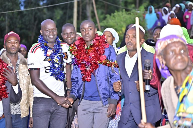 Dennis Kibet (Middle) with Gilbert Kemboi CEO Wakili Kemboi Foundation join by Residents of Chemegong Village after being awarded the Secondary School Scholarship