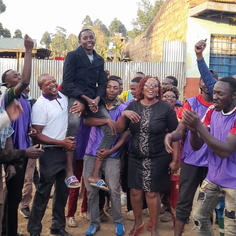 Gathuthuma Mixed Day Secondary School Board of Management chairman CPA Chris Githinji (in white shirt), Kennedy Ndurere and Principal Bilha Muthoni are joined by institution's neighbours in celebrating the steering performance.