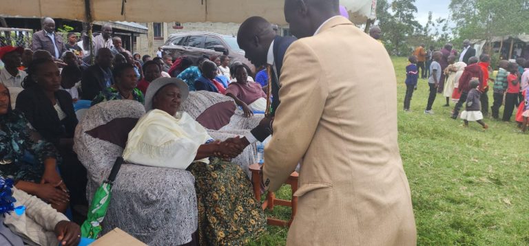 Gilbert Kemboi of Kemboi Foundation shakes hands Sarah Cheruiyot