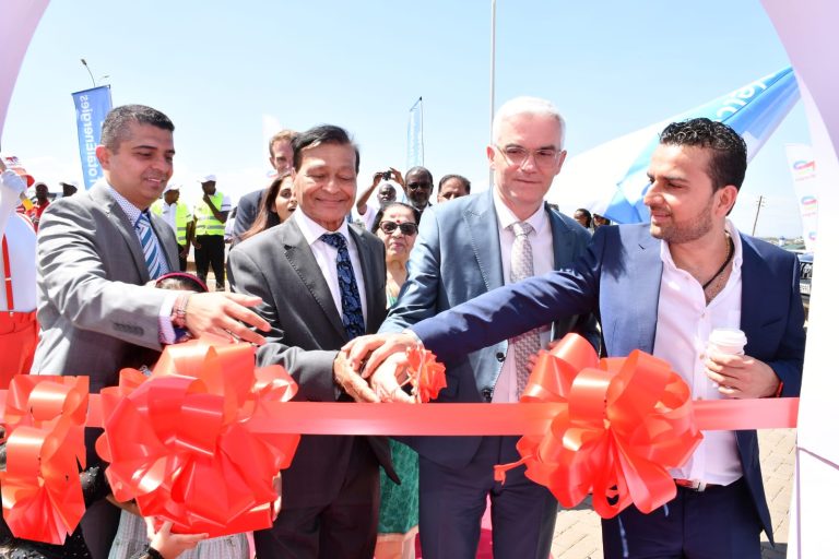TotalEnergies Kenya MD Eric Fanchini (second right) and the proprietor of TotalEnergies Ruiru-Kimbo Service Station Praful Panchmatia