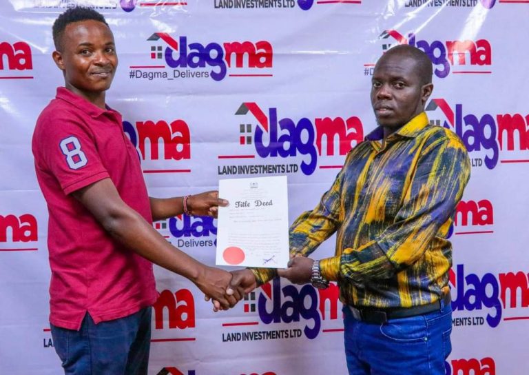 Dagma director Chris Mathea presents a title deed to one of the clients