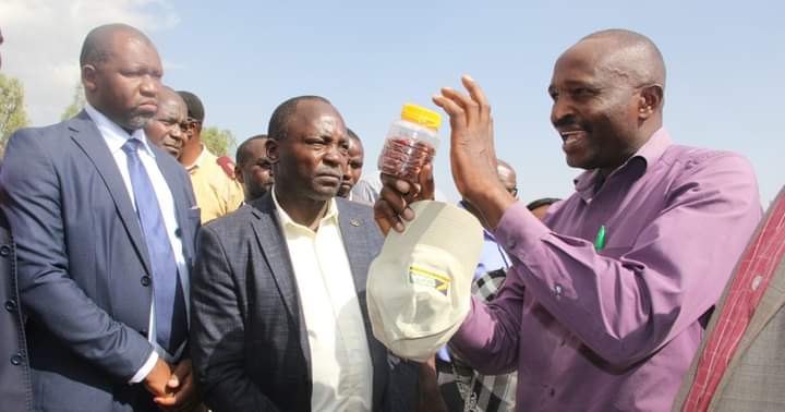 Laikipia County governor Joshua Irungu (centre), his deputy Reuben Kamuri (left) listening as they marked the International Women's day at Solio Village IV yesterday