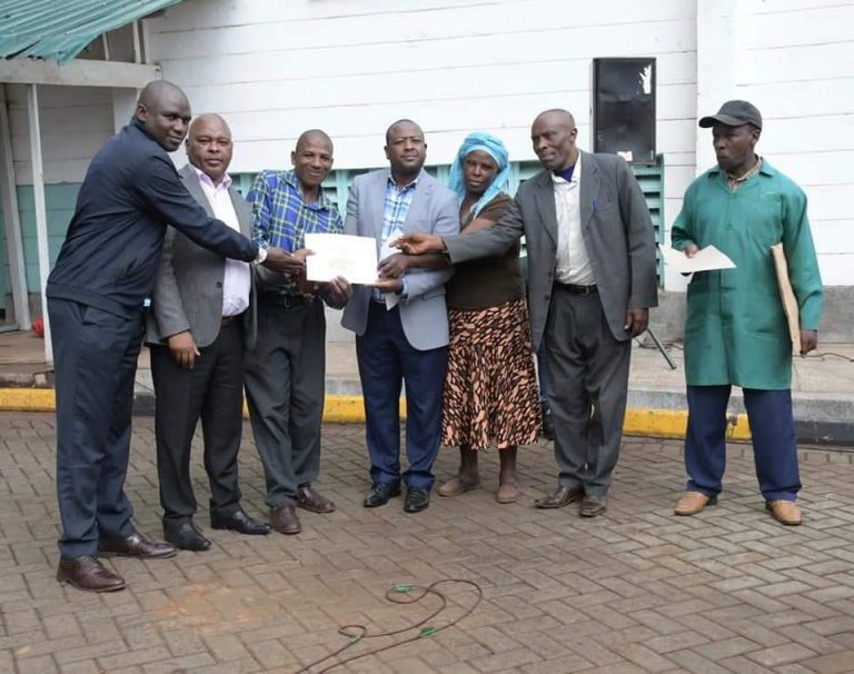 Mr Ichoho with tea farmers at Theta Tea Factory in Gatundu South