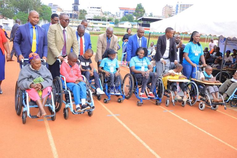 People abled differently receiving wheelchairs at Gusii stadium