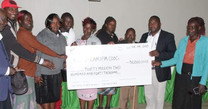 Some of the beneficiary farmers receiving their cheques