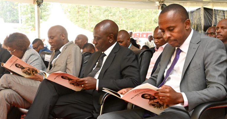 President William Ruto in Kandara, Murang’a County, on Friday during the burial of David Wawerū Ng’ethe — father to Dagoretti South MP John Kiarie (Right)