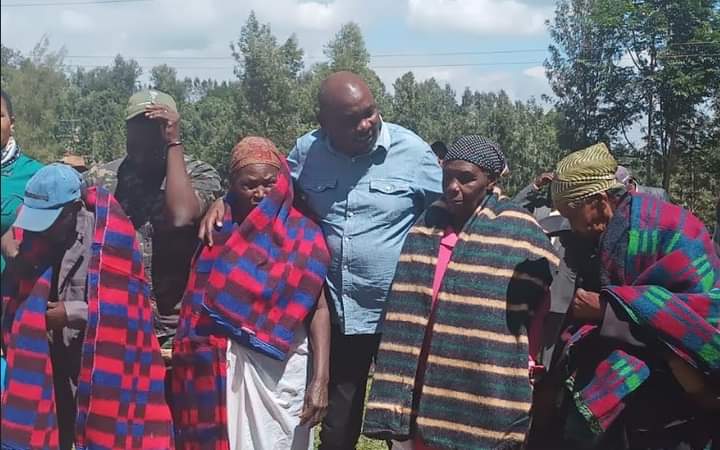 Ahadi Kenya Trust boss Dr Stanley Kamau with some elderly women