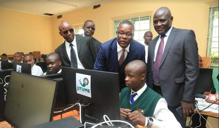 Information, Communications, and The Digital Economy Cabinet Secretary, Eliud Owalo being taken through by a student.