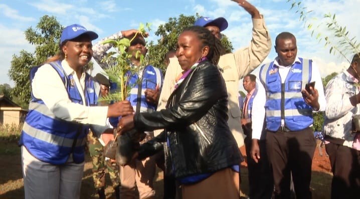 Pastor Dorcas Rigathi handing over a seedling