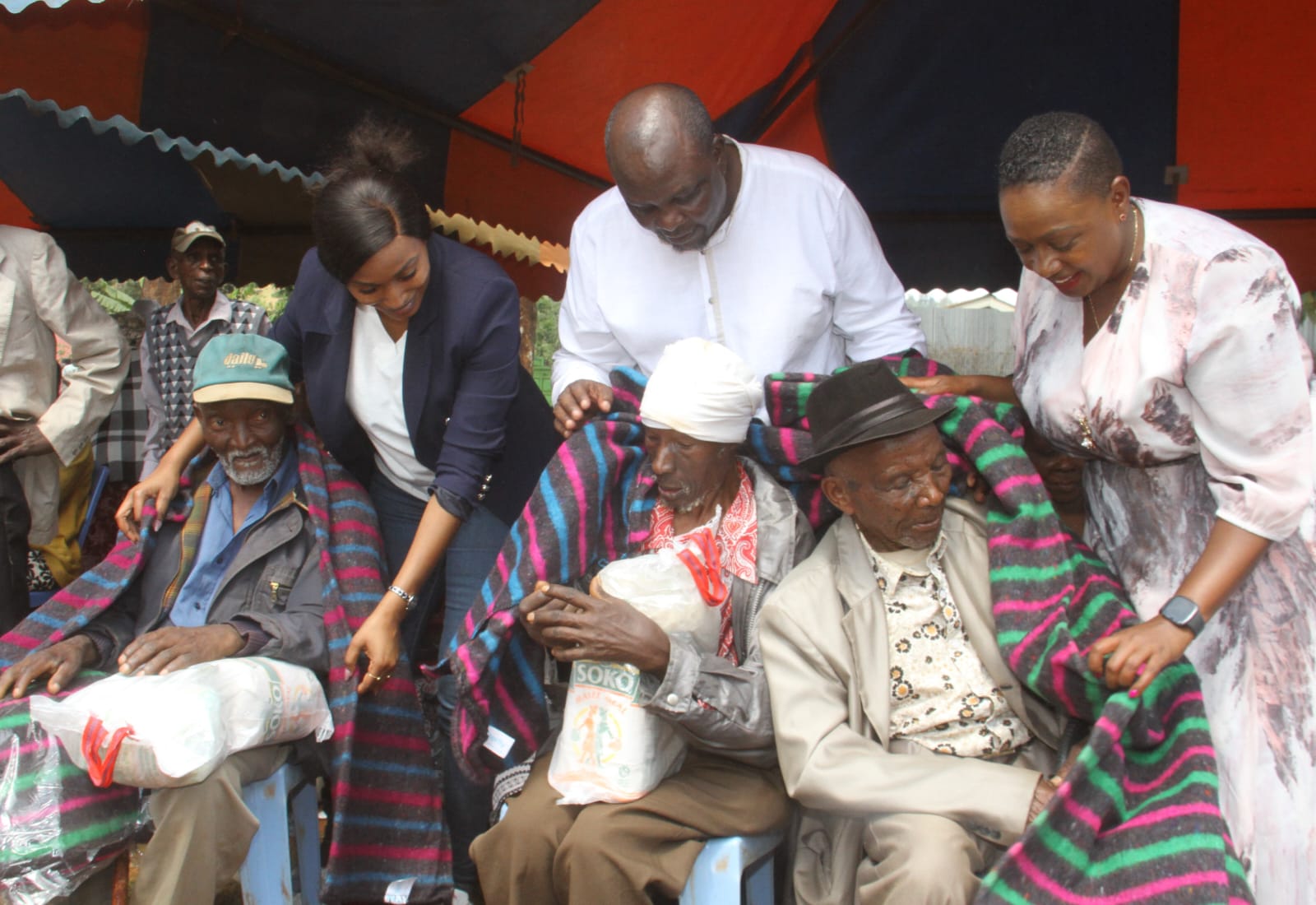 Director of Ahadi Kenya Dr. Stanley Kamau, Nominated MP Sabina Chege and Lotto Foundation CEO Joan Mwaura donate blankets and foodstuff to elderly people in Chui area of Murang’a county