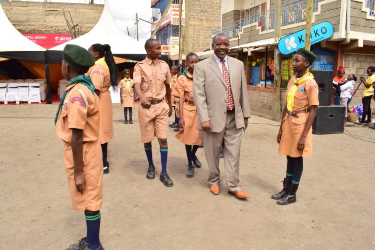 Dr. Paul Wanjohi, founder and director of Sharp Education Centre inspects scouts guard