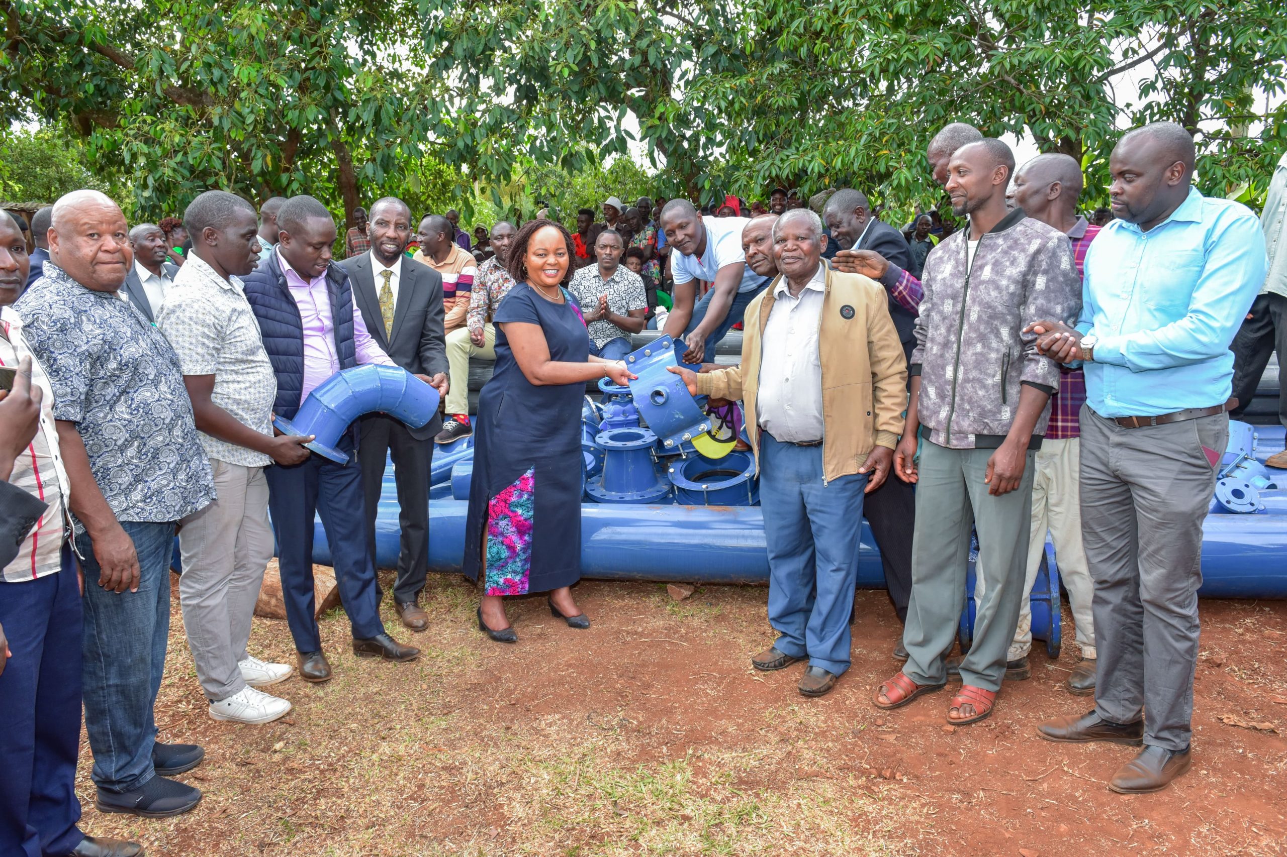 Kirinyaga County governor Ann Waiguru and his deputy David Githanda distributing water supply equipment