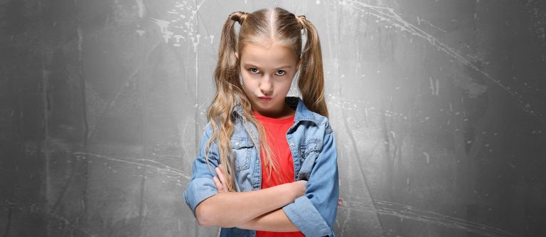 Emotional little girl on grey textured background