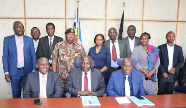 The Principal Secretaries pose for a photo with Heads of Departments after the handing over ceremony