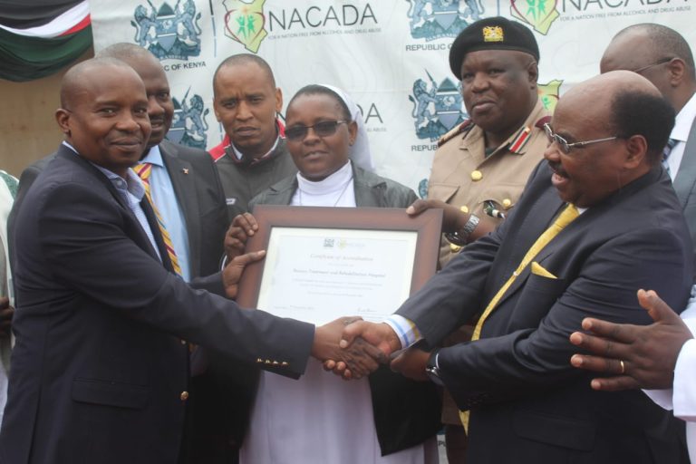 Interior CS Prof. Kithure Kindiki handing over a certificate for Ihururu Rehabilitation Centre to Nyeri Deputy Governor David Kinaniri on Wednesday. Photo/PAUL WANJIRU