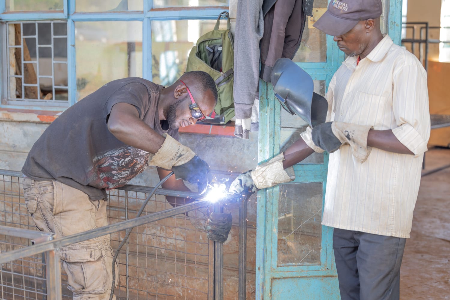 Jason Kamwiti (left) and Peter Githu welding a bed at the Ngorano Vocational Training Centre in Nyeri County.