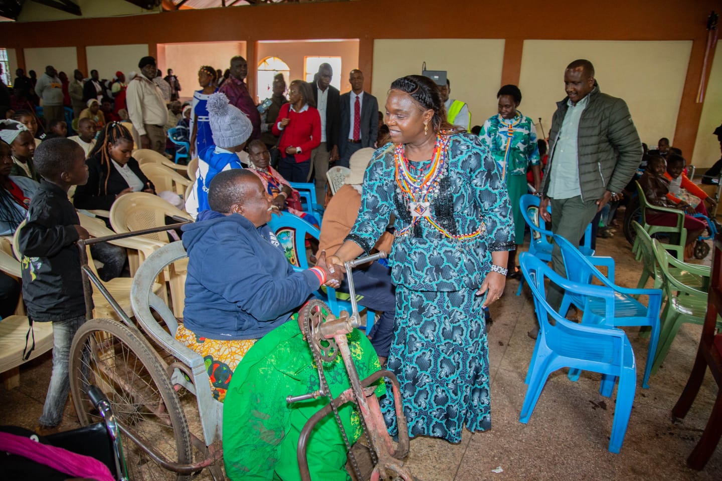 Pastor Dorcas Rigathi greets a PWD at the St. Luke Catholic Church Hall in Loitoktok, Kajiado County yesterday