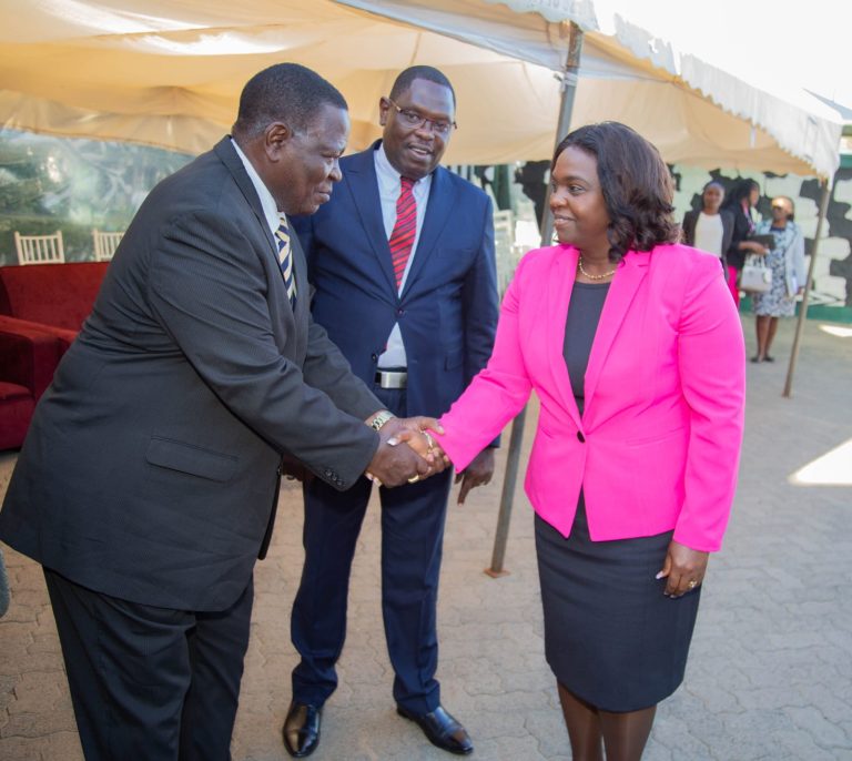 Pastor Dorcas Rigathi shakes hands with Bishop Dr. Mophat Kilioba of PEFA Church