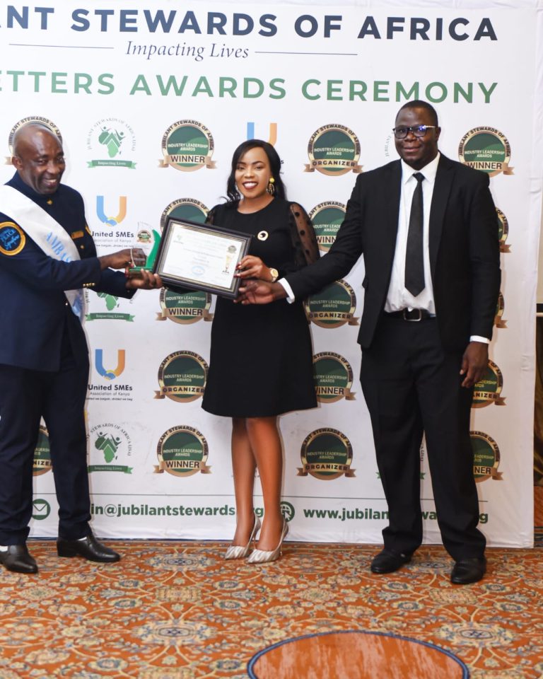 Dr. Ekra Ndung'u receiving an award