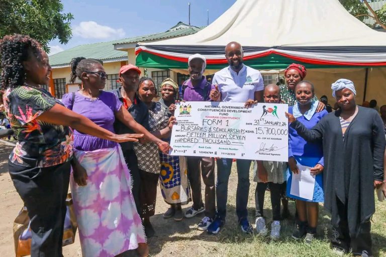 Kasarani MP Ronald Karauri hands over a cheque worth Ksh 15 million to support education for the needy