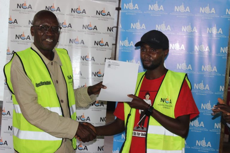 Bobasi Mp Innocent Obiri issuing a certificate to Masonry during the training.