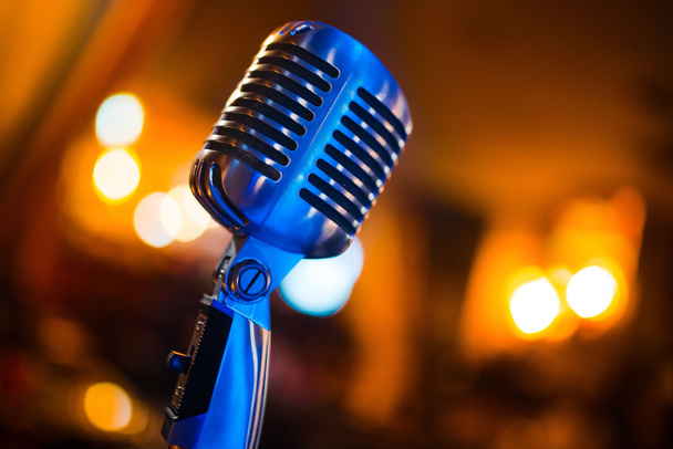 close-up stage retro microphone, orange tint, different focus