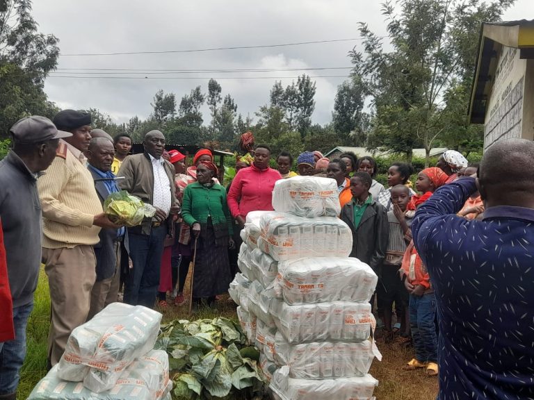 Tana Water Works Development Agency chairman (in white shirt) addressing the floods victims at Githiru Primary School in Nyeri Town constituency yesterday.