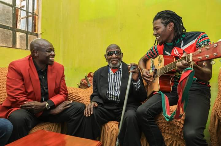 Deputy President Rigathi Gachagua, veteran musician Wanganangù watches as his son entertains them at Muchatha, Kiambu County