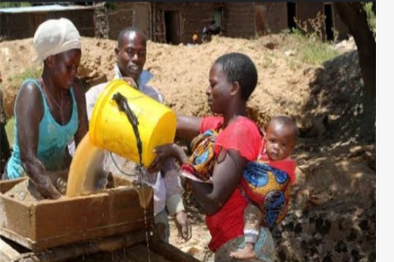Goldminers at Kitere gold mining area washing some sand to get gold