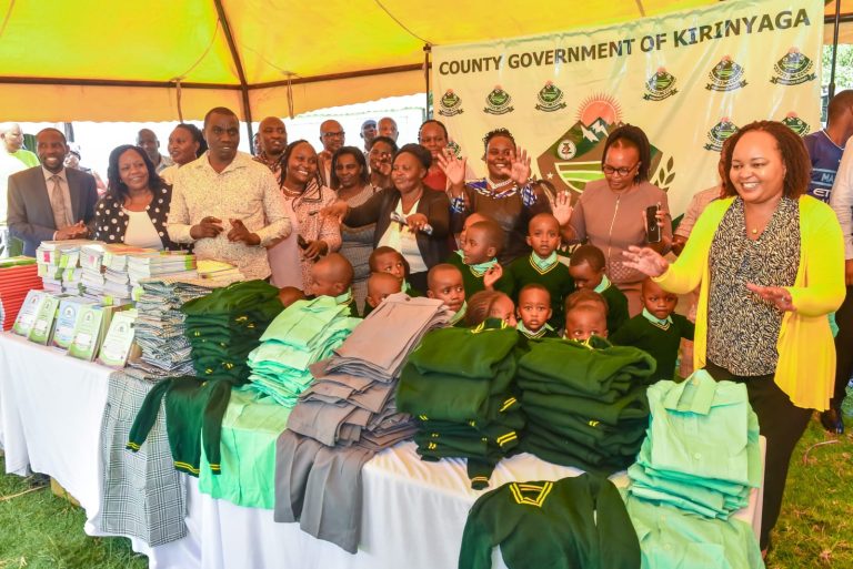 Kirinyaga County governor Ann Waiguru (left) with some pupils, teachers and parents who are beneficiaries of the uniform programme.